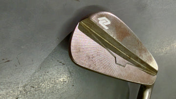 Golf club head on a metallic surface